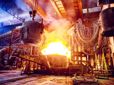 Scrap metal being poured into an Electric Arc Furnace at a Steel Factory